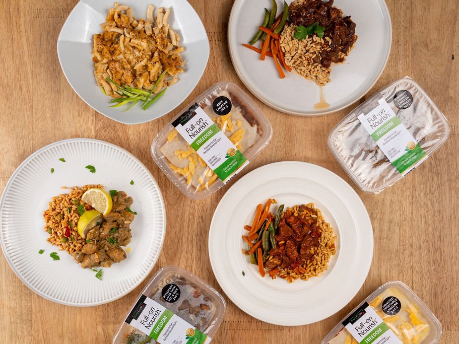 Four plated Full-on meals beside their trays